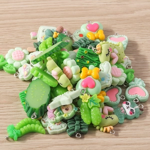 Macro shot of mixed green resin charms with metal loops for DIY jewelry and crafts