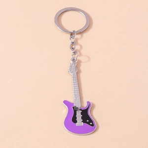Macro detail of purple electric guitar keychain with intricate silver strings and hardware