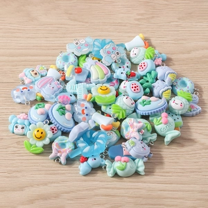 Flat lay of colorful resin charms including flowers and candies for DIY jewelry making