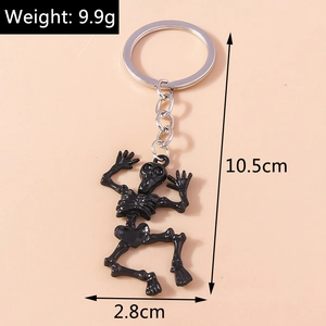 Close-up of black skull keychain showing product weight 9.9g and 10.5cm total length