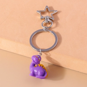 Detailed view of cute purple cartoon dinosaur keychain with silver star carabiner