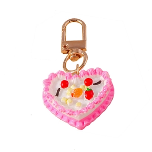 Sweet heart cake keychain with cream frosting and miniature fruit charms on gold clasp