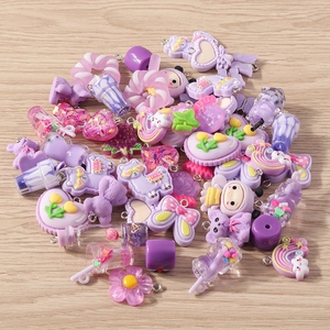 Detailed view of purple resin charms including hearts, flowers, and bears for DIY jewelry