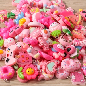 Detailed view of mixed pink resin charms including hearts and flowers for DIY jewelry making