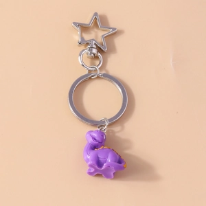 Detail of purple resin dinosaur keychain with a silver star clasp and metal ring