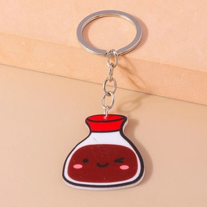 Detailed macro shot of a cartoon seasoning bottle keychain on a textured neutral base