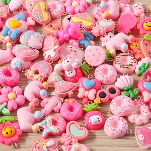 Detailed flat lay of pink cartoon resin charms including hearts flowers and bears for DIY