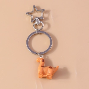 Detail of cute orange dinosaur keychain with silver star clasp and brown spots