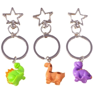 Three colorful cartoon dinosaur keychains with star hooks in green, orange, and purple