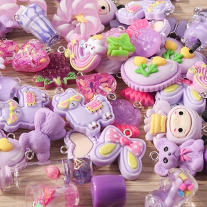 Detail of purple cartoon resin flower and animal charms for DIY jewelry making