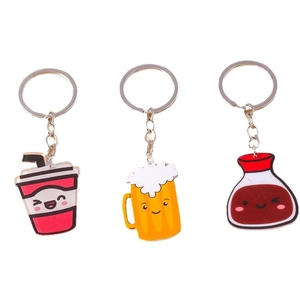 Three cute cartoon beverage keychains including beer mug and soda cup on white background