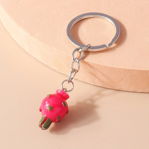 Detailed view of creative dragon fruit keychain with realistic pink texture and silver ring