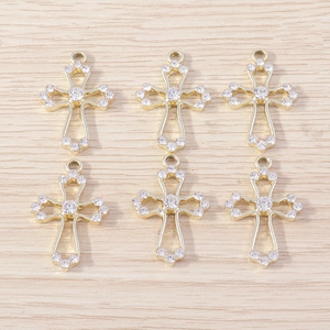 Detail view of 6 gold plated hollow cross pendants with white rhinestones for jewelry making