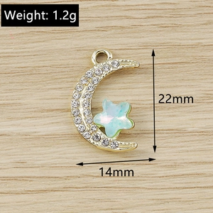Detailed view of gold moon and star pendant charms with dimensions of 22mm by 14mm