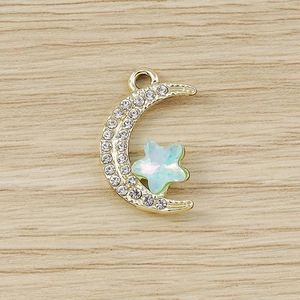 Macro view of gold moon and star pendant with rhinestones for DIY jewelry