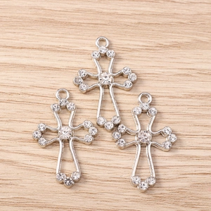 Detailed view of rhinestone-encrusted hollow cross pendants for DIY jewelry making