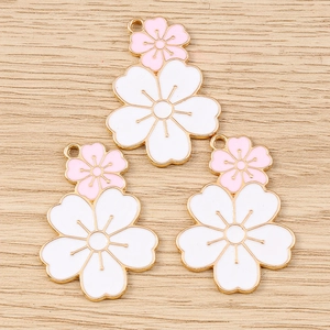 Detailed close-up of three pink and white double cherry blossom alloy flower charms
