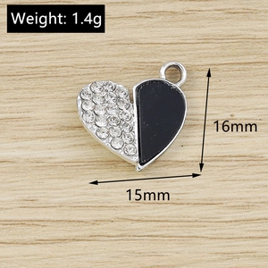Detail view of a 15mm heart pendant with white rhinestones and black enamel design