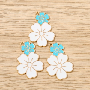 Detail of blue and white double-layer cherry blossom flower charms with gold edges