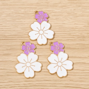 Detail of purple cherry blossom flower pendants with gold edges on wood surface