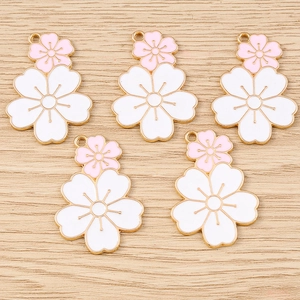 Five cherry blossom flower pendants with pink and white enamel in golden finish