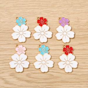 Detailed macro view of six enamel cherry blossom flower charms with colorful alloy petals