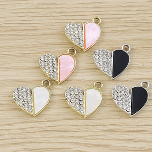 Macro shot of colorful rhinestone heart pendants on a wood surface for DIY jewelry making