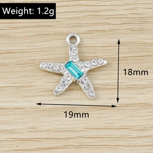 Detailed view of starfish charm with cyan crystal and white rhinestones, 18x19mm size