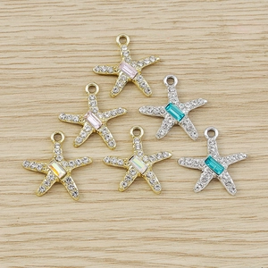 Detailed close-up of rhinestone starfish pendants in gold and silver for jewelry making