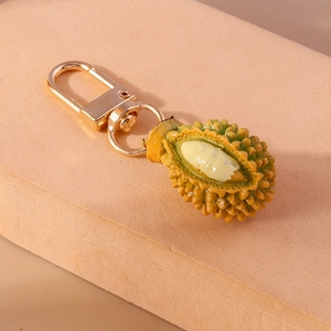 Portachiavi realistico a forma di durian con gancio dorato su base beige
