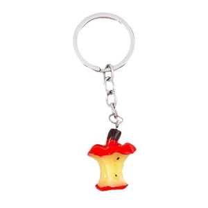 Creative realistic apple core keychain with silver metal ring on white background