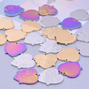 Macro shot of stainless steel heart pendants in gold, silver and iridescent finishes