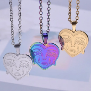 Macro detail of heart-shaped pendants in silver, rainbow, and 18k gold plated finishes