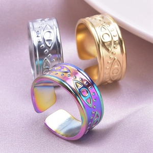 Detailed macro view of adjustable Evil Eye rings in gold, silver, and rainbow steel