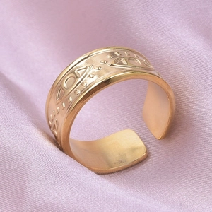 Detailed close-up of adjustable evil eye ring with gold finish on purple satin