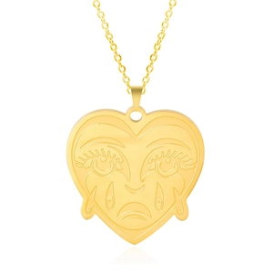 Detail of 18k gold plated heart pendant with artistic face texture and cross chain