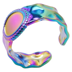 Macro view of rainbow stainless steel adjustable ring with wavy texture and beaded oval detail