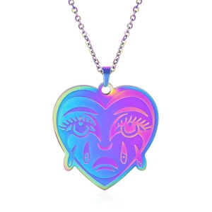 Macro detail of rainbow plated heart pendant with weeping face engraving and fine chain