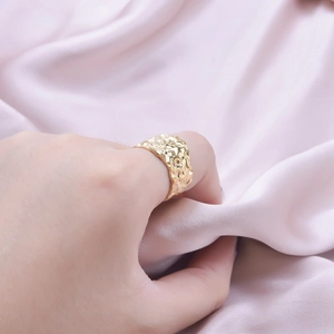 Adjustable golden stainless steel ring with hammered texture worn on finger