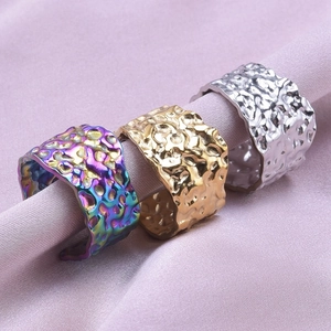 Close-up of set of three wide irregular hammered texture 304 stainless steel rings