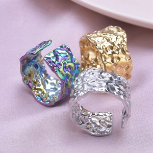 Macro shot of 304 stainless steel open rings with lava texture in rainbow, gold, and silver