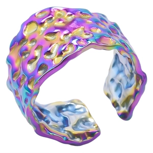 Macro detail showing irregular hammered texture and colorful gradient plating on stainless steel ring