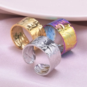 Macro view of textured 304 stainless steel hammered rings in gold silver and purple