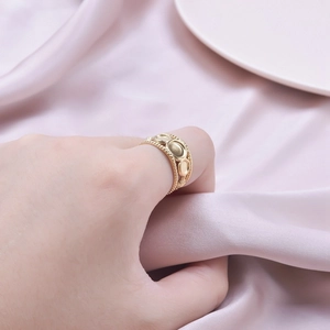 Adjustable wide gold-plated stainless steel ring with embossed patterns and rope edge details