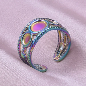 Macro shot of colorful iridescent 304 stainless steel adjustable ring on pink silk fabric