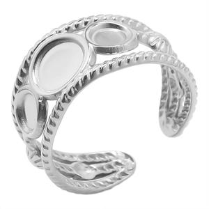 Close-up of adjustable stainless steel ring with triple round gemstone settings and twisted texture
