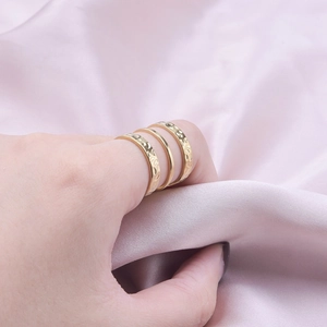 Three-piece stackable 304 stainless steel rings in gold finish worn by a model