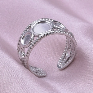 Macro shot of silver open ring with vintage braided edges and triple hollow round settings