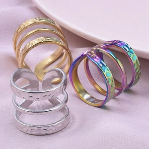 Detailed macro view of triple-layered wavy rings in gold, silver, and rainbow colors