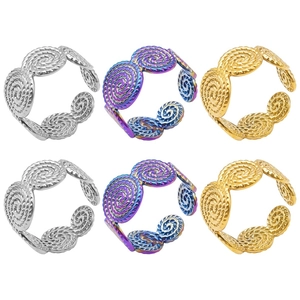 Detailed macro view of spiral twisted rings in gold, silver, and rainbow stainless steel